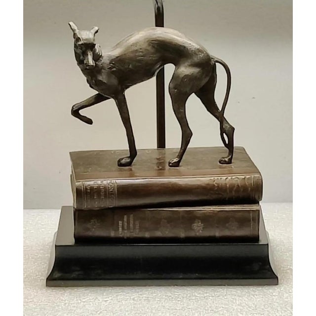 For your consideration. . . A beautiful vintage bronze Whippet/Greyhound standing on top of a stack of faux books with a...