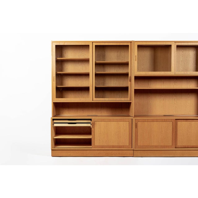 This set of three vintage mid century Danish modern oak wood bookcase display cabinets by Poul Hundevad was made in...