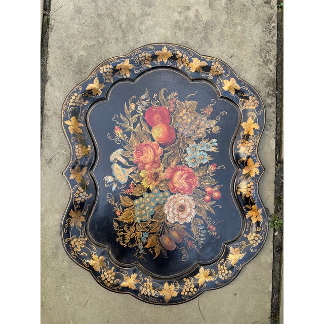 Decorative vintage tole tray featuring an exuberant hand-painted still life of flowers and fruit against a deep black...