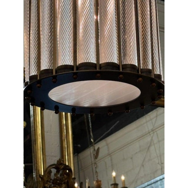 Modern Murano twist glass lanterns with antique brass frames. The chandelier has been professionally rewired, comes with...