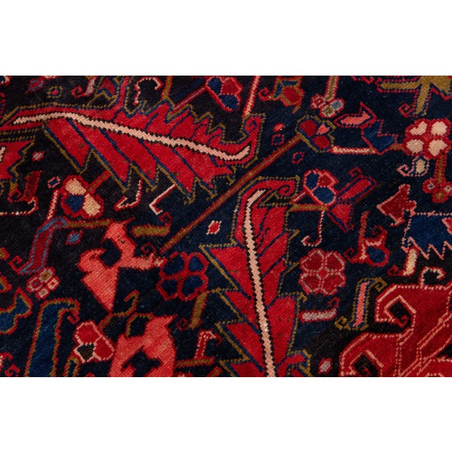 Beautiful vintage Persian Hamadan hand-knotted wool runner with a navy blue field. This piece has a red frame and...