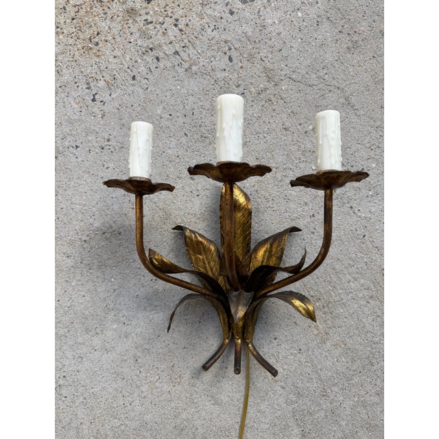 Pair of Spanish gold gilt 3-candle sconces with leaf motif designs. Newly rewired with new wax candle covers 15”l x 9”d x...