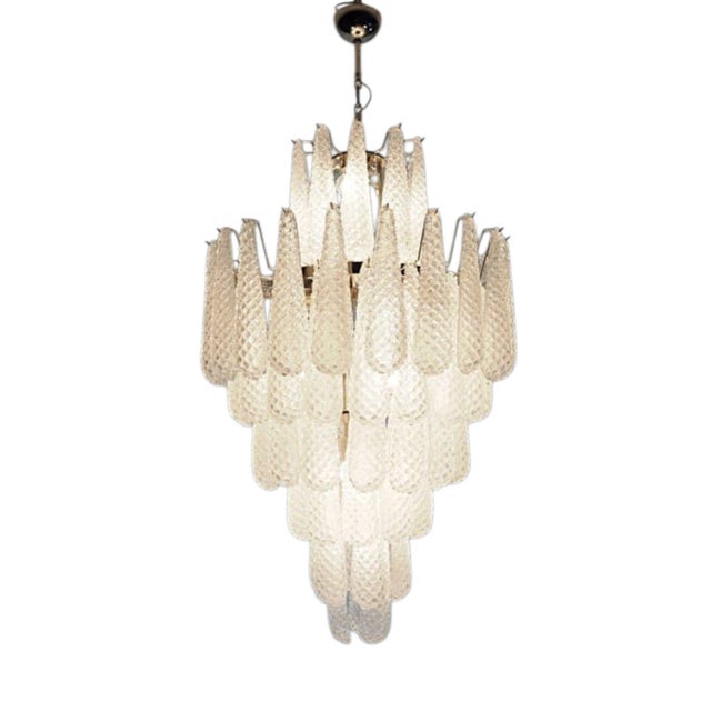 A sculptural chandelier in authentic Murano glass, featuring a sophisticated composition of teardrop shaped elements in...