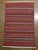 Handwoven Afghan Meymana kilim flatweave rug featuring a striped field with alternating horizontal bands of fine geometric...