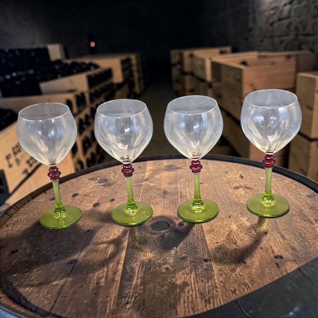 The product is a stunning set of four Italian wine glasses with green and red stems. Made of art glass, these red wine...