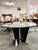 Dining table by Cattelan Italia, featuring a large round glass top that enhances the sculptural base underneath, from the...