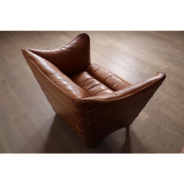A beautiful pair of early edition lounge chairs model “Cayenne” in original cognac leather and coconut palm wood, made by...