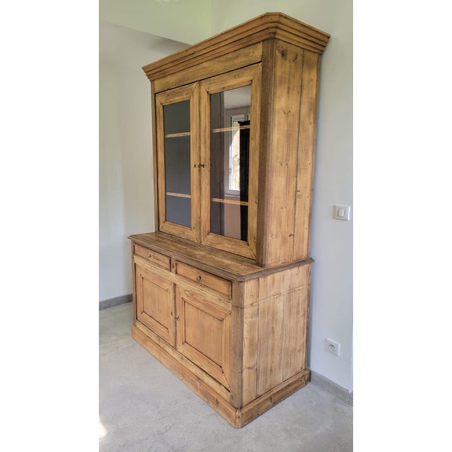 Two-piece cabinet Lower section with two doors and two drawers Upper section with two large glass doors Both keys and...