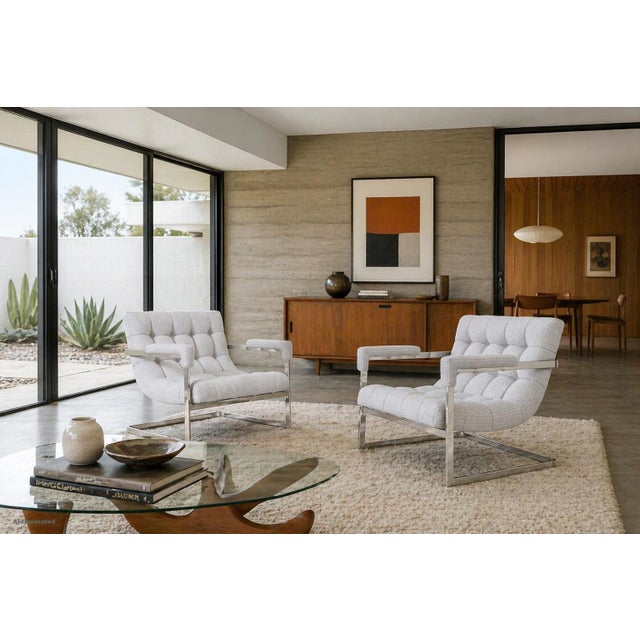 Striking and effortlessly architectural, this pair of chrome scoop lounge chairs captures the essence of 1970s modern...