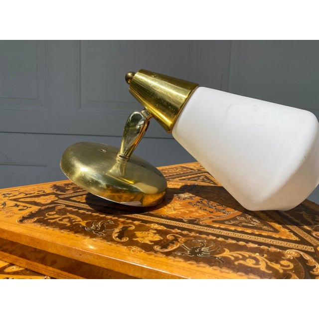 Gorgeous mid century modern hardwired wall sconce. Upscale brass fittings and a frosted atomic shaped shade. There is no...