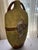 This vase showcases a prominent fish motif with an inlaid mosaic or textured relief scale pattern. It is made during the...