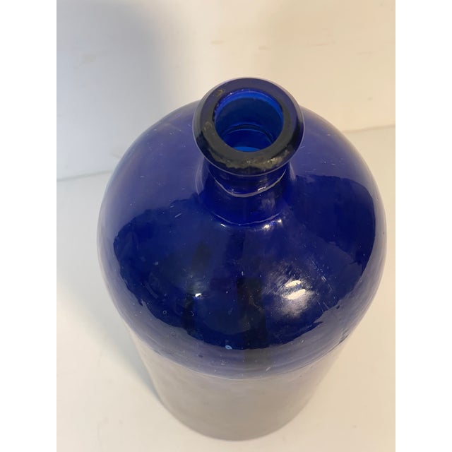Antique American cobalt blue glass 14” tall bottle.