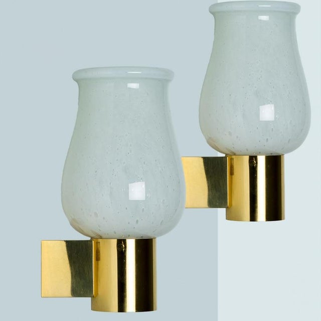 Pair of Opaline Glass Wall Lights by Glashütte Limburg, 1960. The opaline glass is mounted on a gold colored frame....