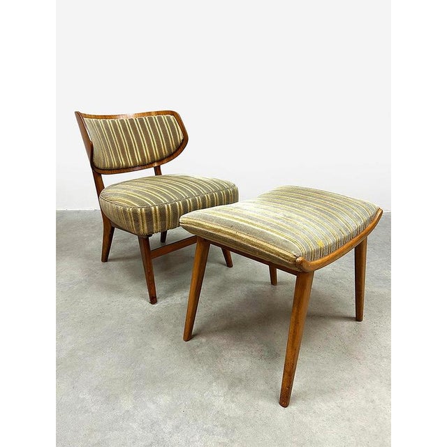 A mid-century treasure! This stylish vintage wingback lounge armchair with a matching ottoman exudes elegance. Designed by...