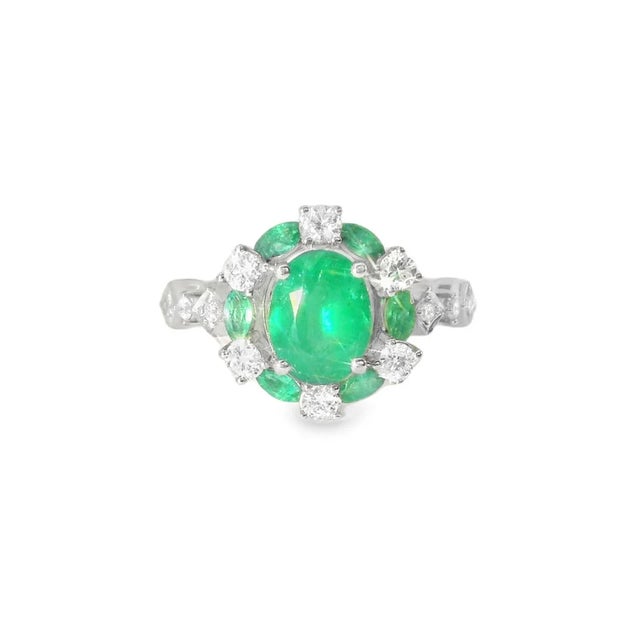 This stunning 14K white gold ring showcases a beautiful cluster of natural emeralds accented by sparkling diamonds. The...
