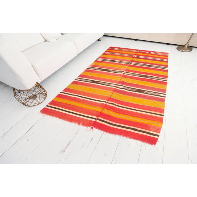 This is a vintage Turkish Oushak rug from the Mid 20th Century. The piece was hand-knotted.