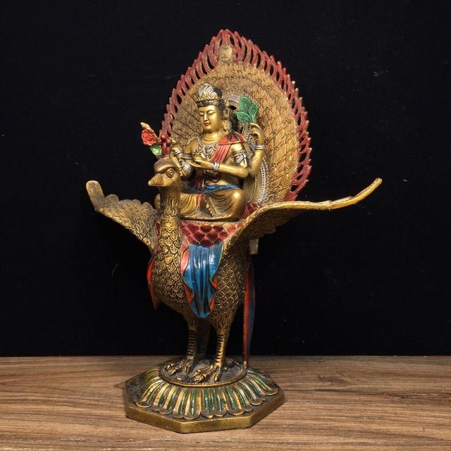 This vintage devotional sculpture is crafted from gilt bronze or copper and depicts the Mahamayuri (Peacock King) riding a...