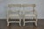 A pair of Swedish whitewash painted wood armchairs from the Midcentury period, with open backs, custom upholstered seats,...