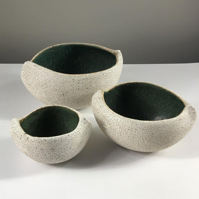 Set of 3 ceramic boat shape bowls by Yumiko Kuga. Measures: W 6" x D 8.5" x H 4" Born in Japan, Yumiko Kuga has been a...