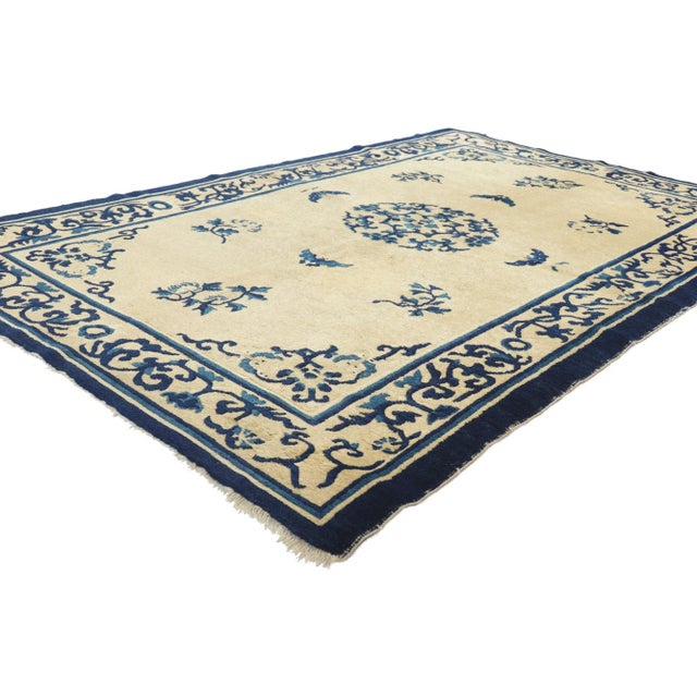 77193 Antique Chinese Peking Rug, 04’01 x 06’08. This hand-knotted wool antique Chinese Peking rug features a round open...