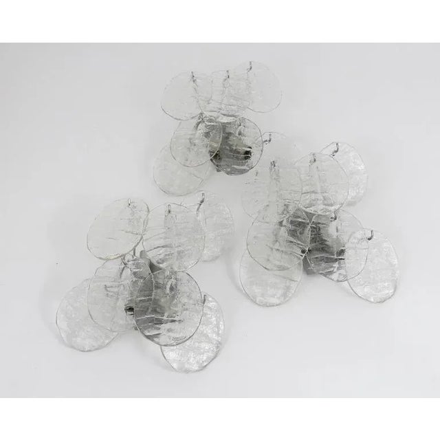 Beautiful Austrian wall light, executed by Kalmar Vienna in the 1960s. Seven leaf-shaped ice glass discs on a silver...