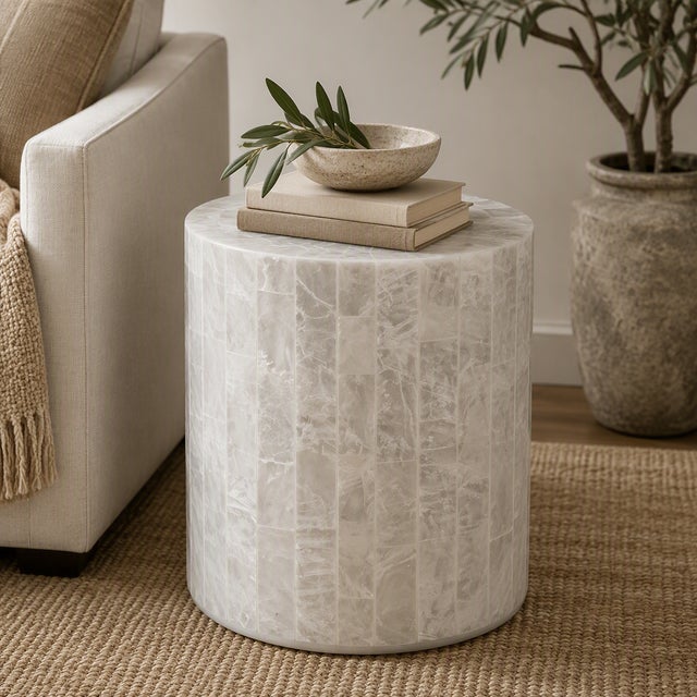 Elevate your space with this elegant cylinder accent stool crafted from luminous white capiz shell. Featuring a mosaic...