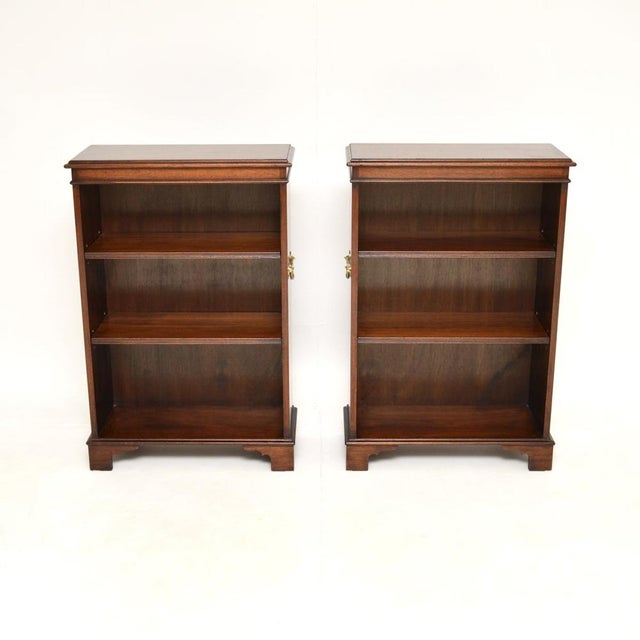 A wonderful pair of antique military campaign style open bookcases. They were made in England, and date from around the...