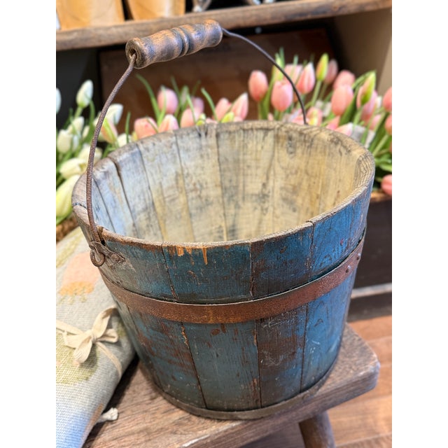 A beautiful and authentic 19th century Shaker wooden bucket, featuring original worn blue paint and classic bentwood...