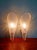 Pair of cone-shaped wall sconces in textured, clear plastic, circa 1970. Each sconce is compatible with an E14 LED bulb....