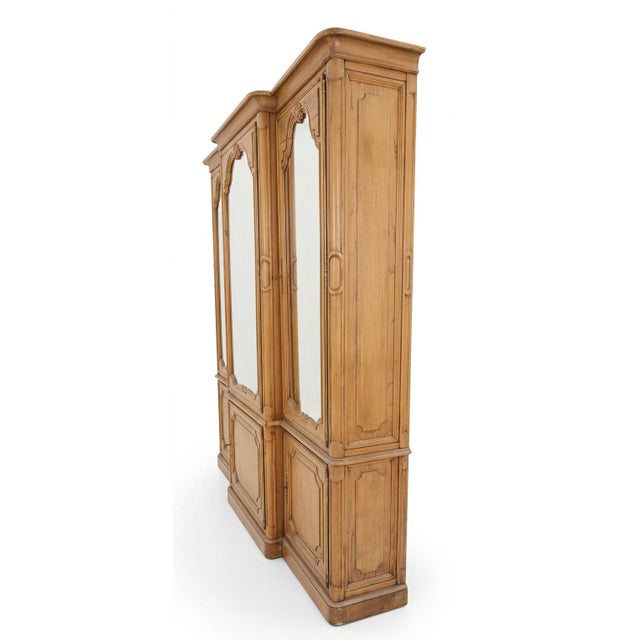 This French Provincial style oak three-piece china display cabinet features a classic breakfront design crafted from...