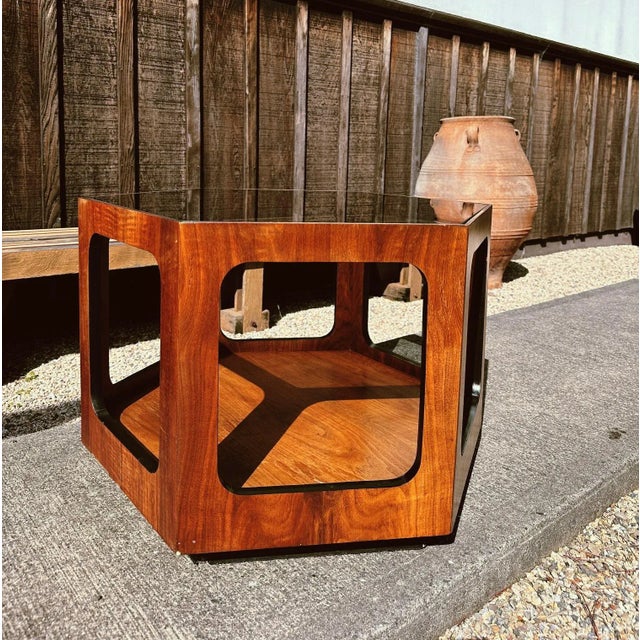 Smoke glass table top inset into stunning walnut veneer clad base creates a seamless look. Second tier beautifully...