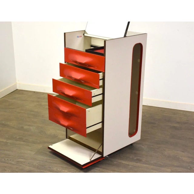 A space age red and orange molded plastic DF-2000 valet dressing cabinet designed by Raymond Loewy. Made in France. Vanity...