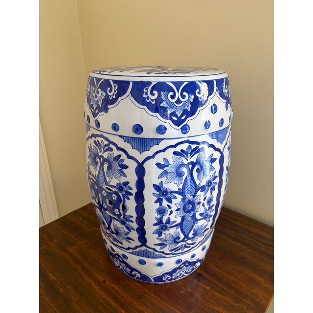 A classic blue and white porcelain garden stool, decorated with traditional Chinese motifs and stylized floral elements....