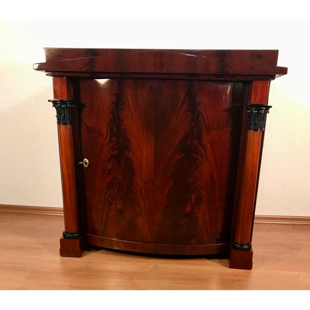 Biedermeier Side Cabinet, Northern Germany, circa 1820 – Mahogany Veneer This elegant early 19th-century Biedermeier side...
