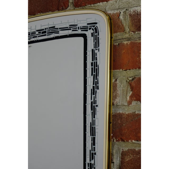 Rearview mirror with screen printing, gold outline and black border.