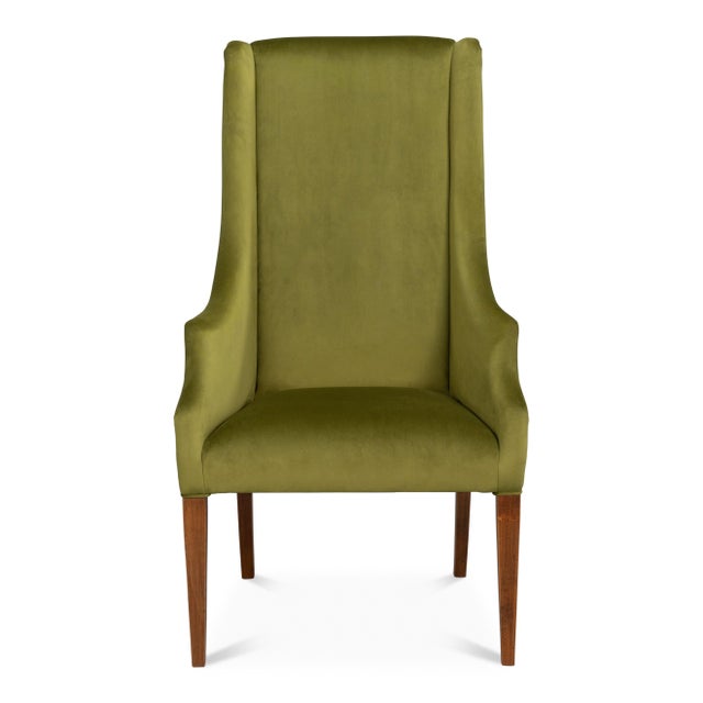 Deep olive velvet covers a 49-inch back and sloping, wing-like arms, giving the seat the scale and presence of a host...
