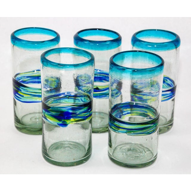 Set of 5 hand-blown vintage tumblers, each a testament to the skill of Mexican glass artists. These glasses boast a...