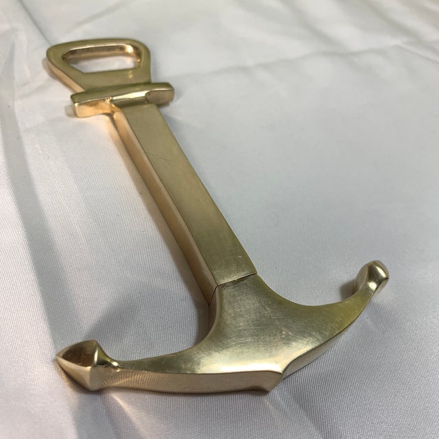 The item in the image is a vintage nautical brass combination bottle opener and hidden corkscrew. it heavily resembles the...