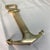 The item in the image is a vintage nautical brass combination bottle opener and hidden corkscrew. it heavily resembles the...