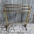 A handsome piece of vintage brass bathroom furniture — a freestanding three-bar towel or blanket rack, raised on tapered...