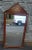 An Early 20th Century Empire Neoclassical Brass Mounted and Mahogany Wall Mirror in good condition. Solid Mahogany frame....