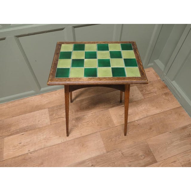 A Liberty London Heart Carved Tiled Top Occasional Table This piece is being offered from a dispersal sale of Arts and...