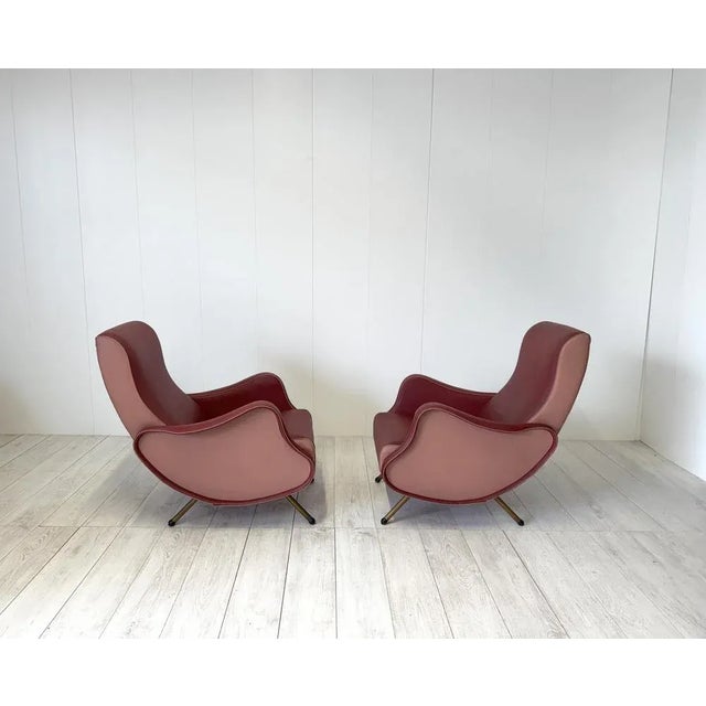 Pair of 1950s armchairs of Italian production with metal label Fratelli Bergallo, Turin. Structure in vinyl leather, metal...