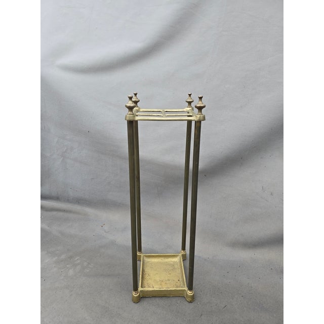 A vintage Umbrella stand in an aged brass and decorative finials. This piece could also be used to hold a collection of...
