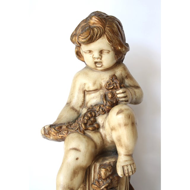 Stunning 19" antique Italian figurative putti. Draped with pretty floral garland and sitting on a sculptural column...