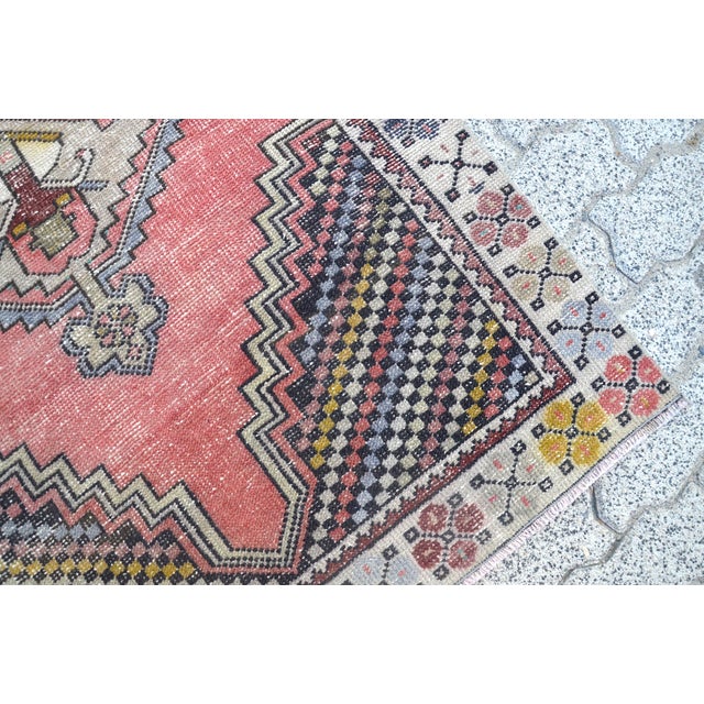 This is a vintage Turkish Oushak rug from the 1960s. The piece was hand-knotted.