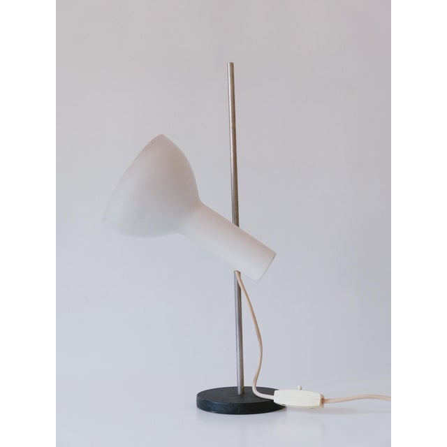 Rare & minimalistic mid century modern desk light or table lamp. Adjustable height and lamp shade. Designed and...