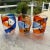 Classic Mario Badioli face tumbler, in vibrant shades of orange and blue with the face details in raised black.Signature...