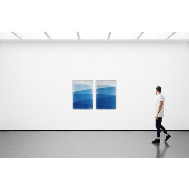 This handmade monotype cyanotype presents a serene composition of layered blue forms that evoke distant mountain ridges...