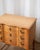 A 1970s Danish Modern oak side chest attributed to Henning Kjærnulf, showcasing sculptural lines and warm, honey-toned...